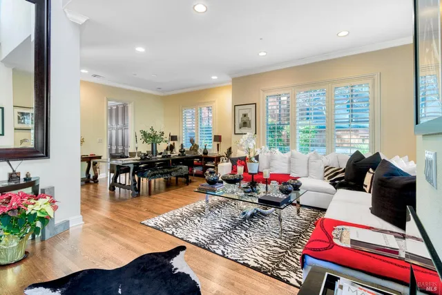 a living room with furniture and floor to ceiling windows