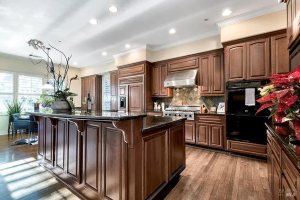 a kitchen with lots of counter top space and wooden floor