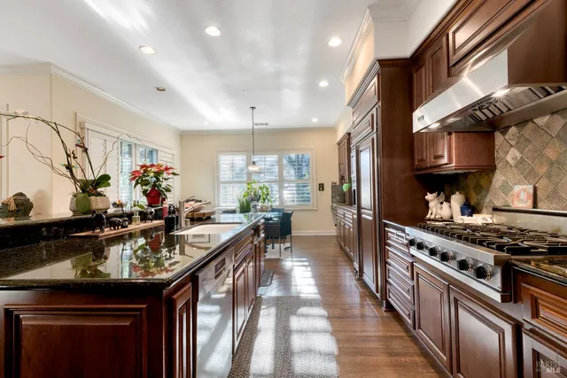 a kitchen with stove and refrigerator