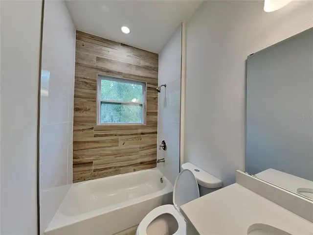 a bathroom with a bathtub and shower