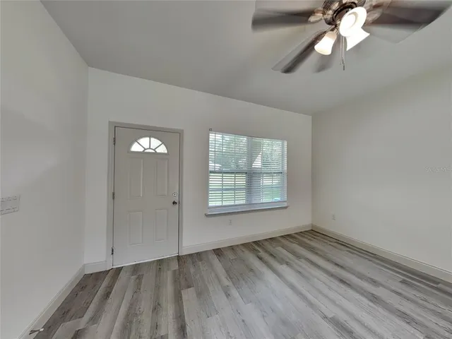 wooden floor in an empty room with a window