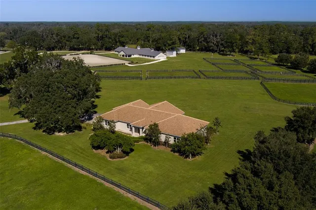 an aerial view of a house with a lake