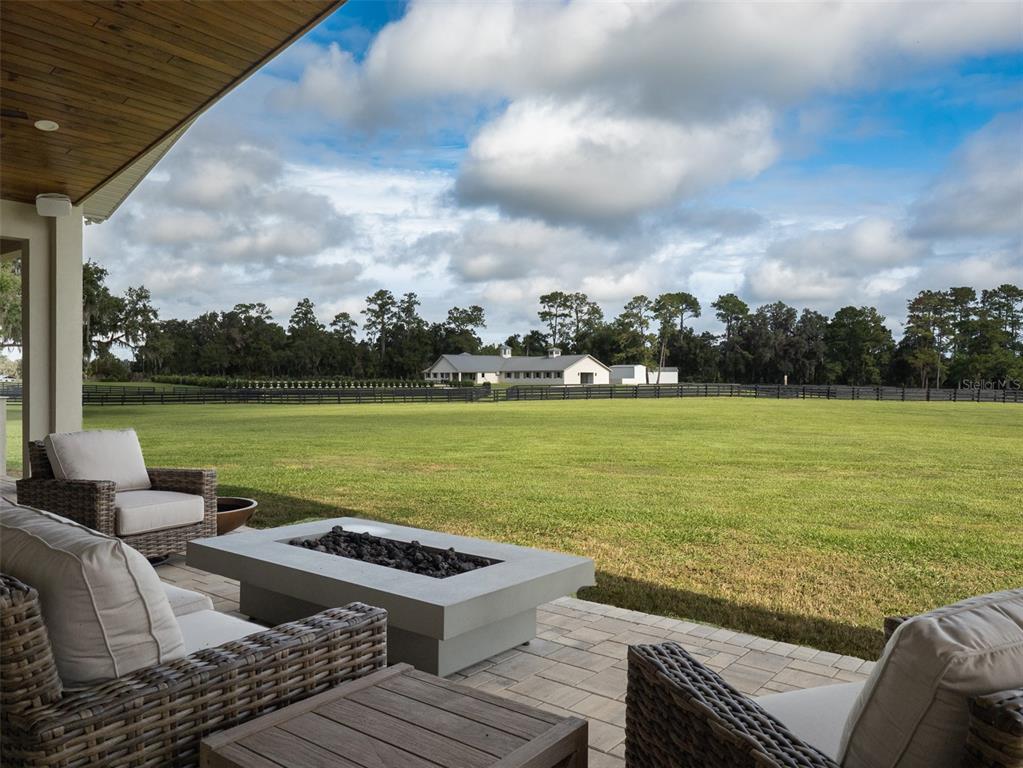 15225 Northwest 112th Place Road Morriston, FL 32668 - Photo 19 of 39 a view of a terrace with couches and ocean view