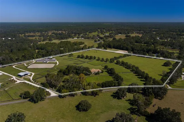 an aerial view of a residential houses with outdoor space