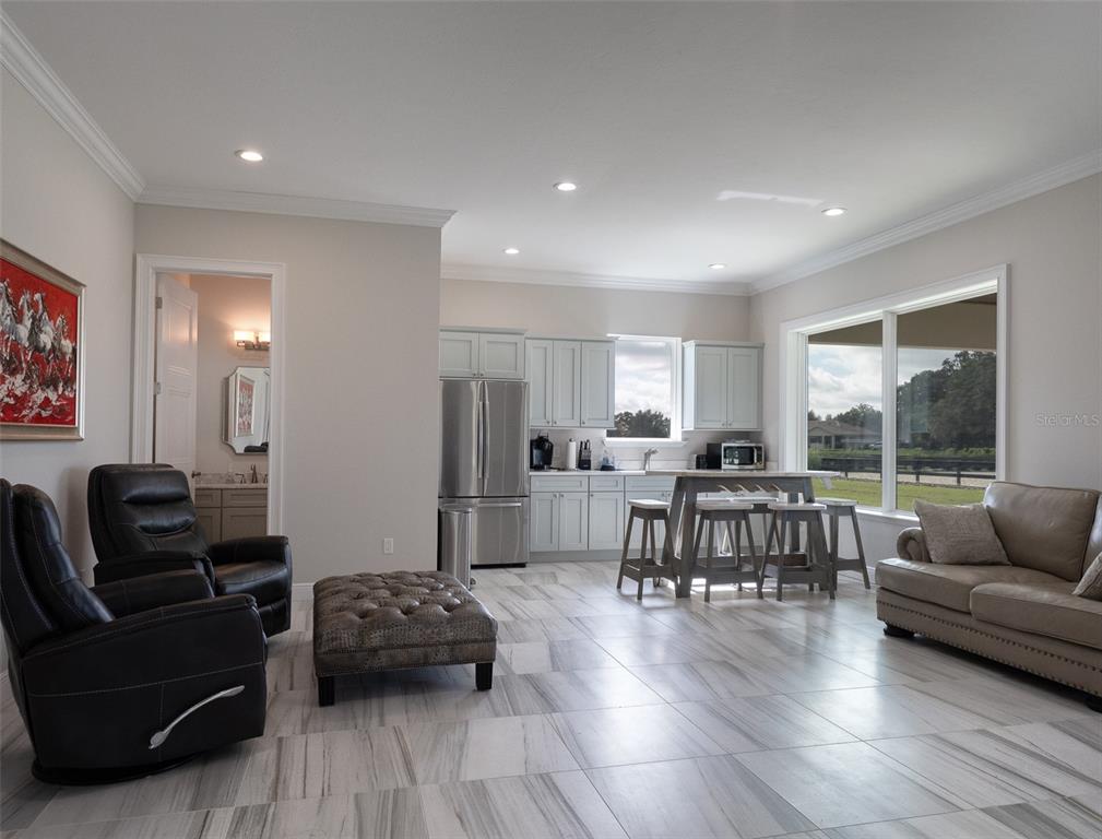 15225 Northwest 112th Place Road Morriston, FL 32668 - Photo 26 of 39 a living room with furniture and a large window