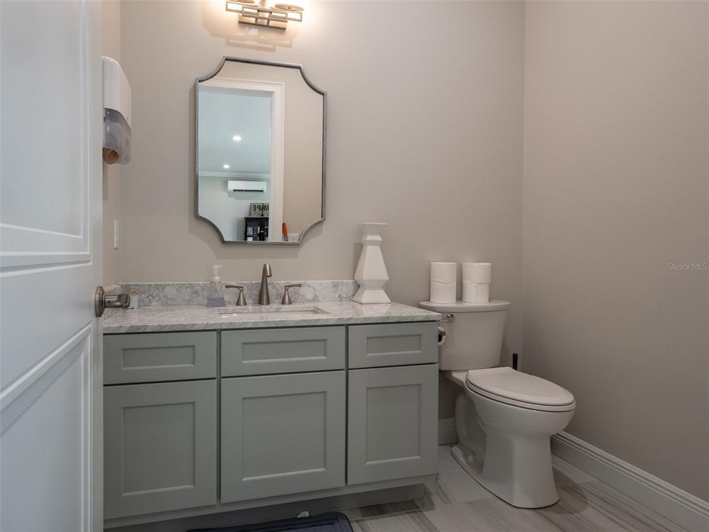 15225 Northwest 112th Place Road Morriston, FL 32668 - Photo 27 of 39 a bathroom with a toilet a sink and mirror