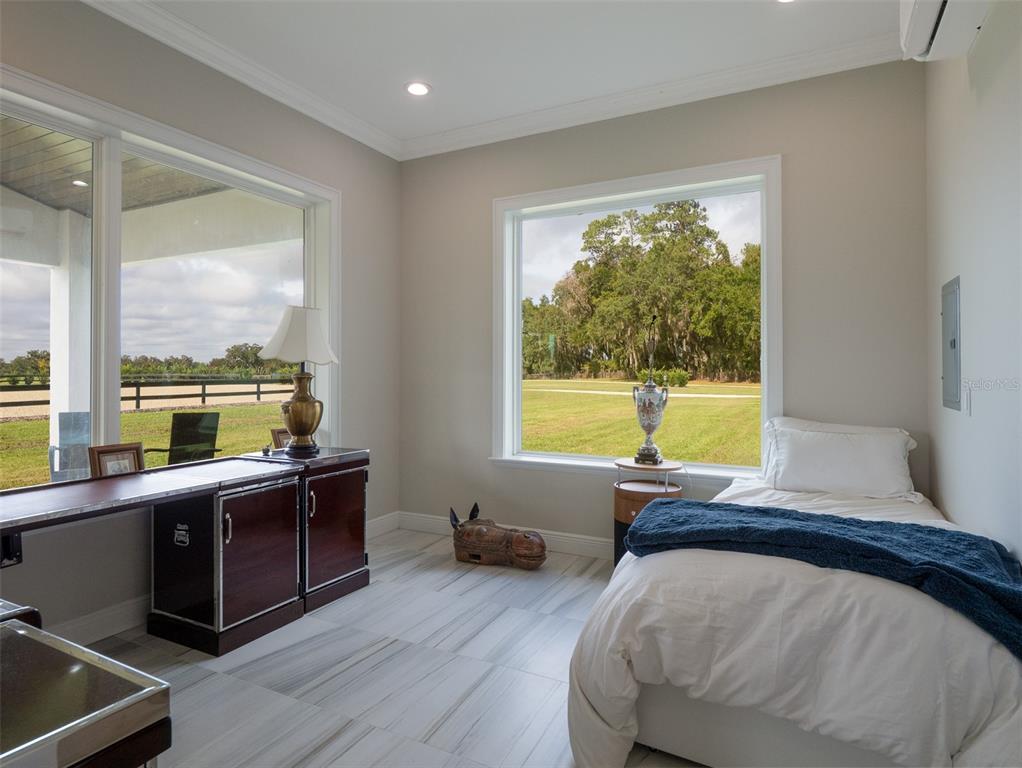 15225 Northwest 112th Place Road Morriston, FL 32668 - Photo 29 of 39 a bedroom with furniture and a large window