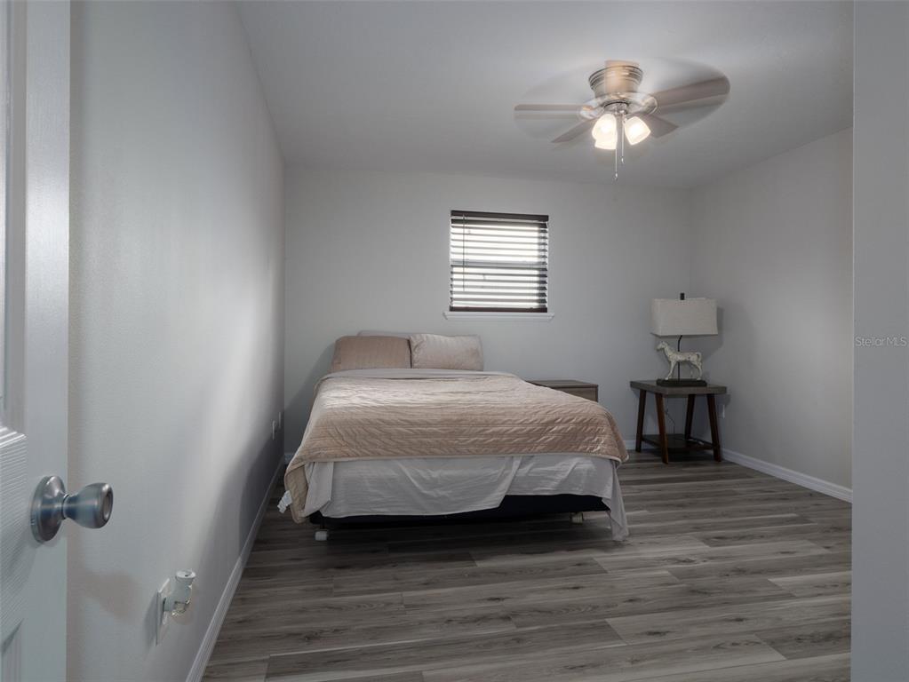 15225 Northwest 112th Place Road Morriston, FL 32668 - Photo 35 of 39 a bedroom with a bed and a chandelier