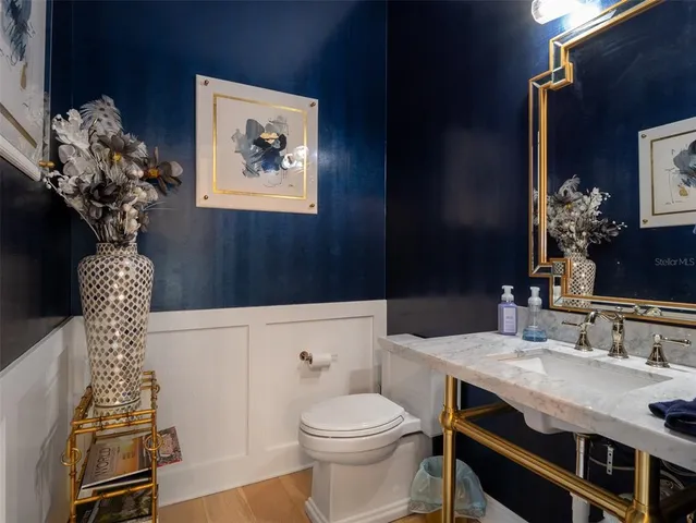 a bathroom with a sink a toilet and mirror