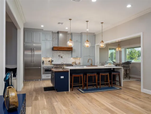 a large kitchen with a large counter top appliances and cabinets