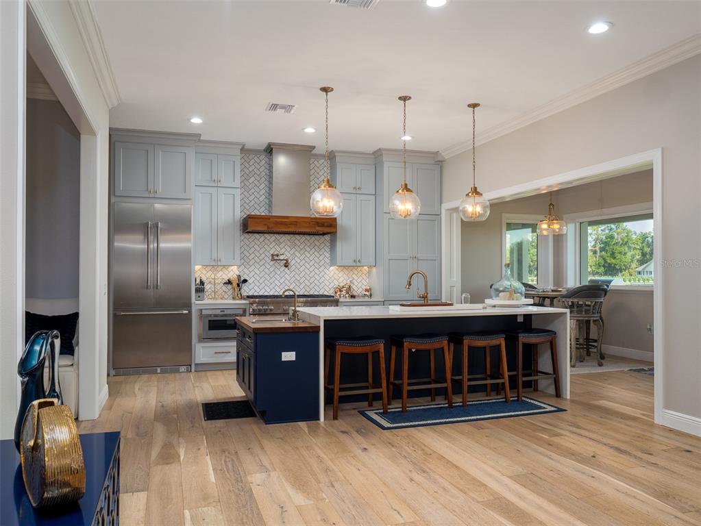 15225 Northwest 112th Place Road Morriston, FL 32668 - Photo 7 of 39 a large kitchen with a large counter top appliances and cabinets