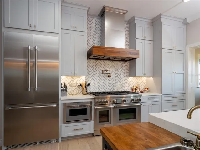 a kitchen with stainless steel appliances granite countertop a stove and a refrigerator