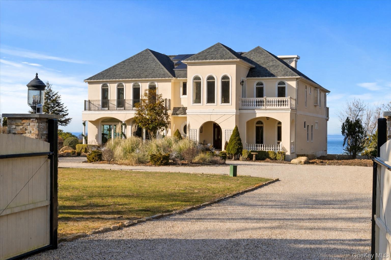 Perched high above the Sound, this exquisite home boasts expansive water views and glowing sunsets