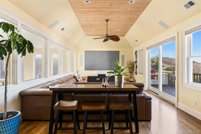 a living room with a table and a flat screen tv