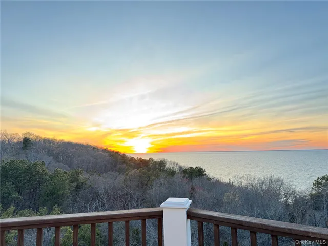 a room with pool table and windows