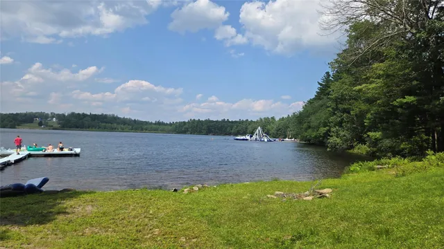a view of a lake with houses in the back