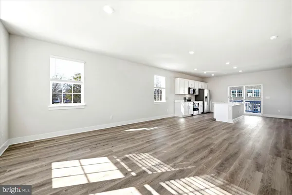 a kitchen with stainless steel appliances a refrigerator sink and microwave
