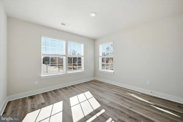 a view of a bedroom with wooden floor