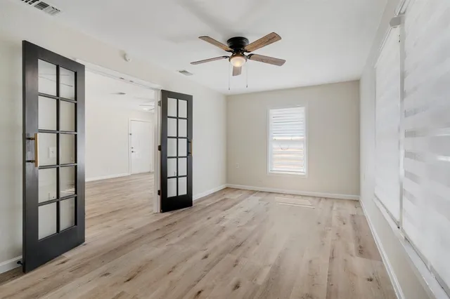 wooden floor in an empty room with a window