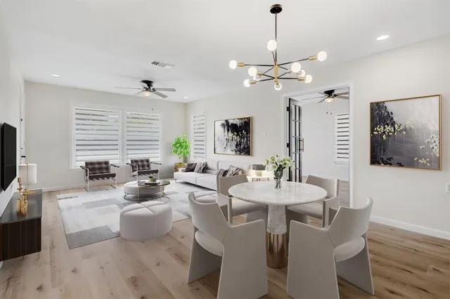a view of a a dining room with furniture window and wooden floor