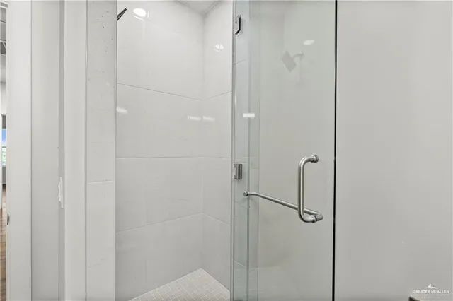 a bathroom with a glass shower door