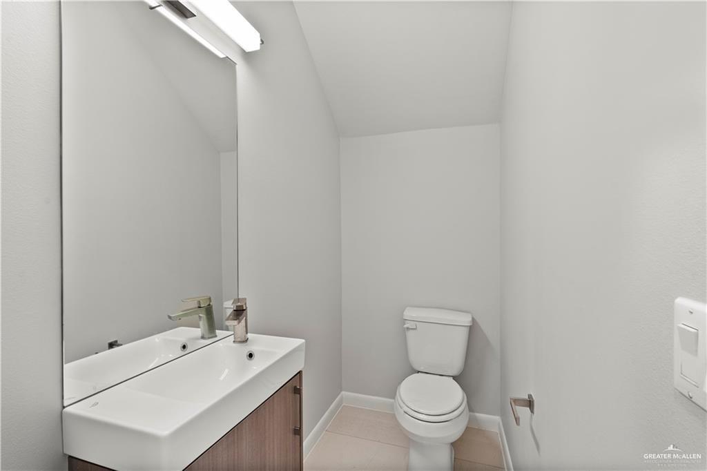 3512 Vanessa Lane, Unit 2 Weslaco, TX 78599 - Photo 18 of 21 a bathroom with a toilet a sink and mirror