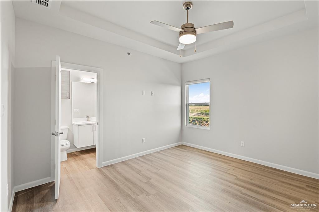 3512 Vanessa Lane, Unit 2 Weslaco, TX 78599 - Photo 8 of 21 wooden floor in an empty room with a window