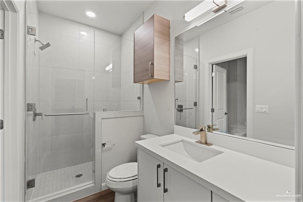 3512 Vanessa Lane, Unit 2 Weslaco, TX 78599 - Photo 9 of 21 a bathroom with a sink toilet a mirror and shower