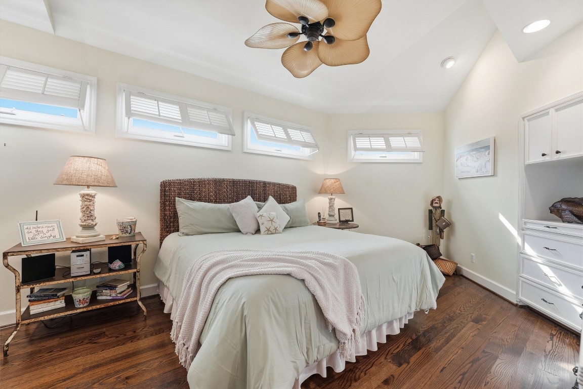 16635 Jamaica Cove Road Jamaica Beach, TX 77554 - Photo 17 of 45 a bedroom with a bed and wooden floor