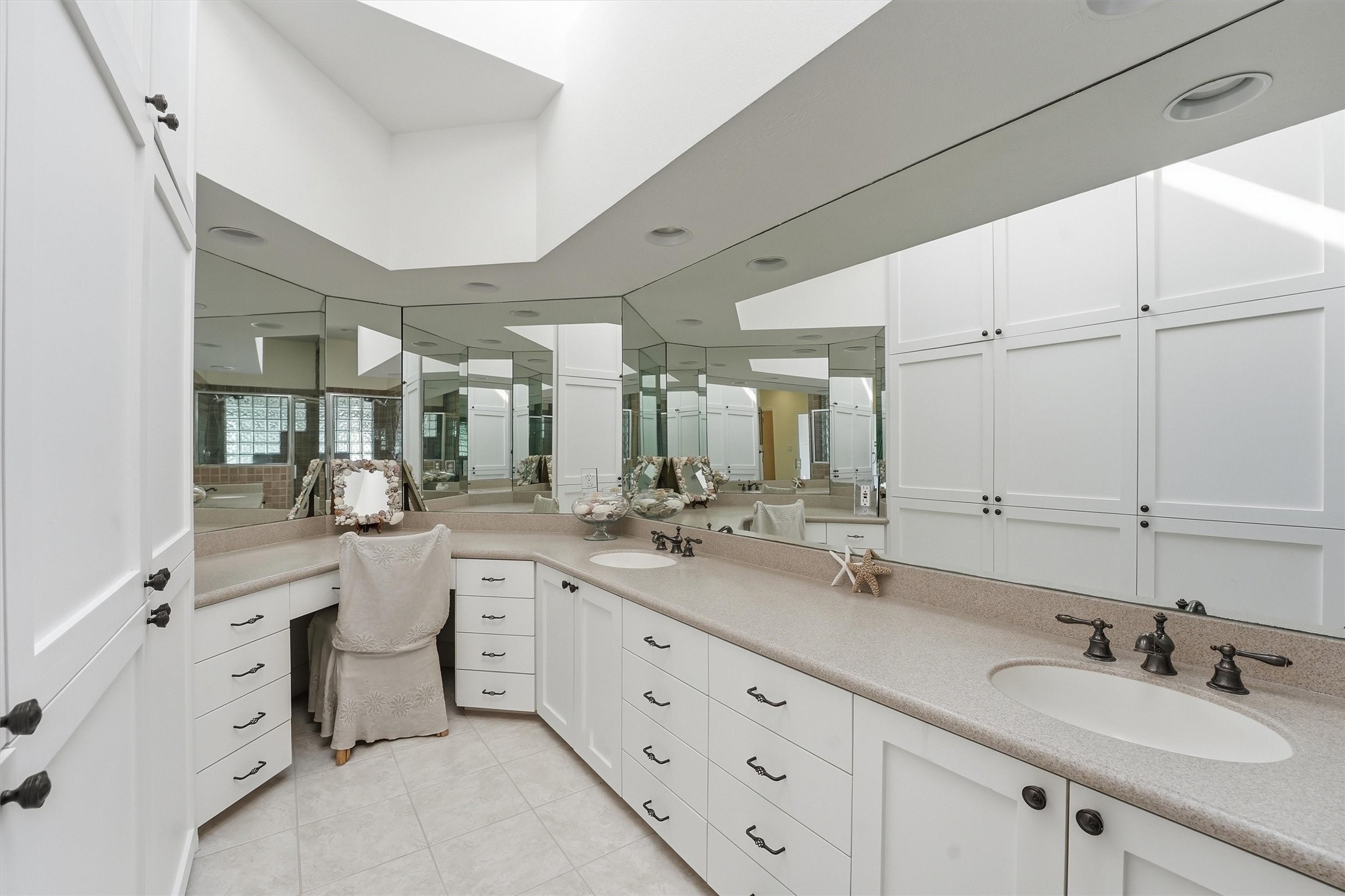 16635 Jamaica Cove Road Jamaica Beach, TX 77554 - Photo 22 of 45 a bathroom with double vanity sinks and a mirror