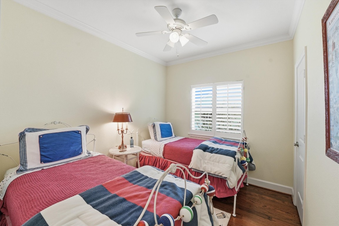 16635 Jamaica Cove Road Jamaica Beach, TX 77554 - Photo 28 of 45 a bedroom with two beds and a chandelier