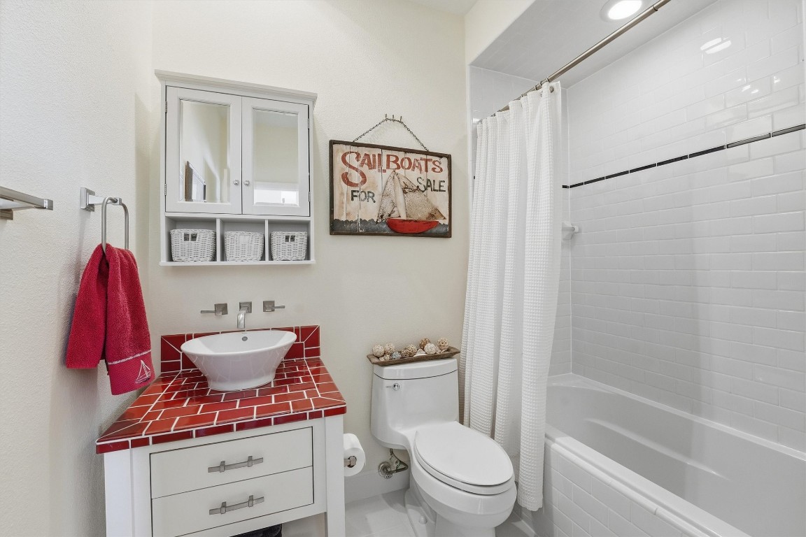 16635 Jamaica Cove Road Jamaica Beach, TX 77554 - Photo 29 of 45 a bathroom with a toilet a sink and a bathtub
