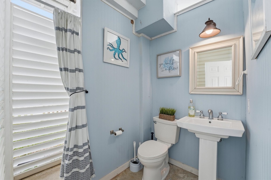 16635 Jamaica Cove Road Jamaica Beach, TX 77554 - Photo 31 of 45 a bathroom with a toilet sink and mirror