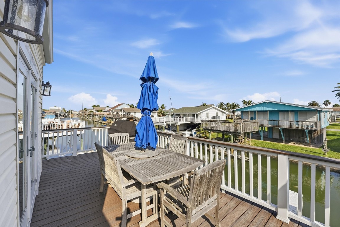 16635 Jamaica Cove Road Jamaica Beach, TX 77554 - Photo 37 of 45 a view of a balcony with table and chairs