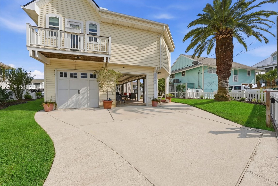 16635 Jamaica Cove Road Jamaica Beach, TX 77554 - Photo 41 of 45 a house with palm tree in front of it