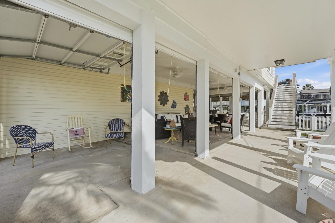 16635 Jamaica Cove Road Jamaica Beach, TX 77554 - Photo 5 of 45 Expansive covered outdoor living area with Wayne Dalton Roll up doors for easy transition to protect the furnishings and bar area from the elements when not in use.