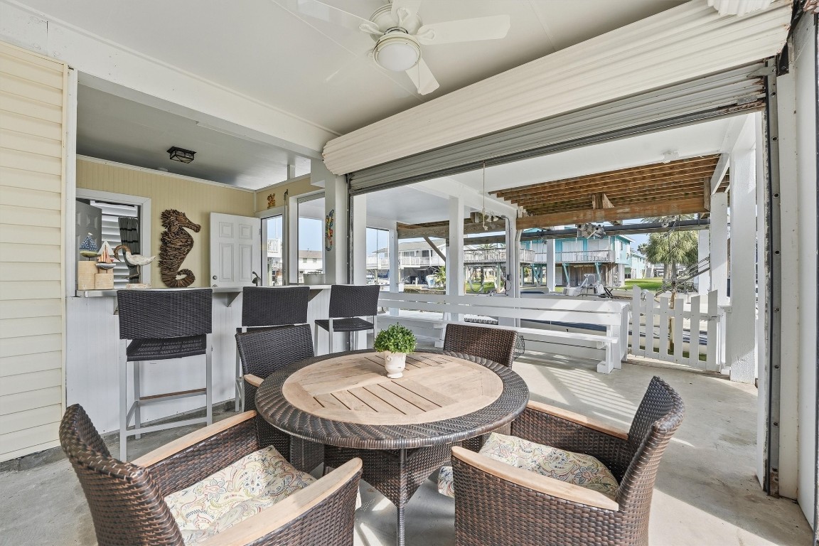 16635 Jamaica Cove Road Jamaica Beach, TX 77554 - Photo 6 of 45 a view of a dining room with furniture window and wooden floor