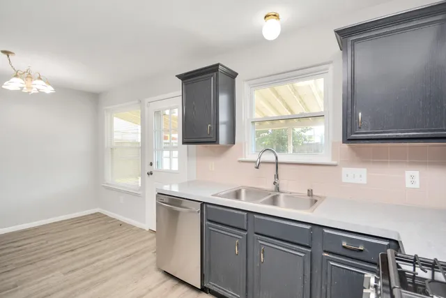 a kitchen with a refrigerator sink and cabinets