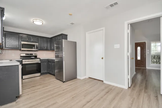 a kitchen with a sink cabinets and window
