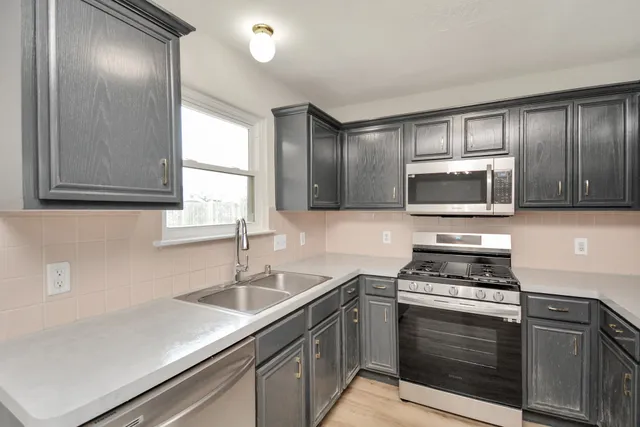 a kitchen with a refrigerator stove and sink