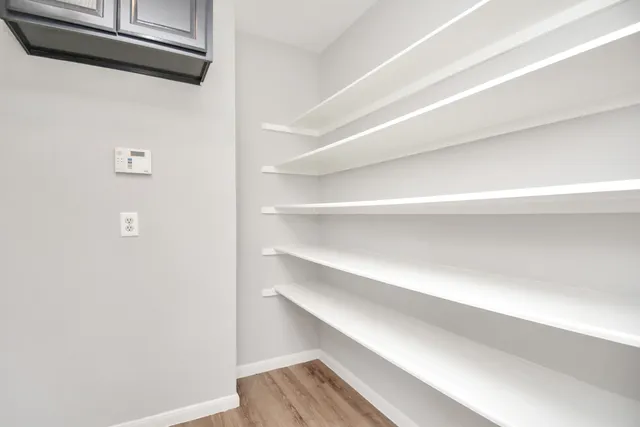 a kitchen with granite countertop cabinets stove top oven and microwave