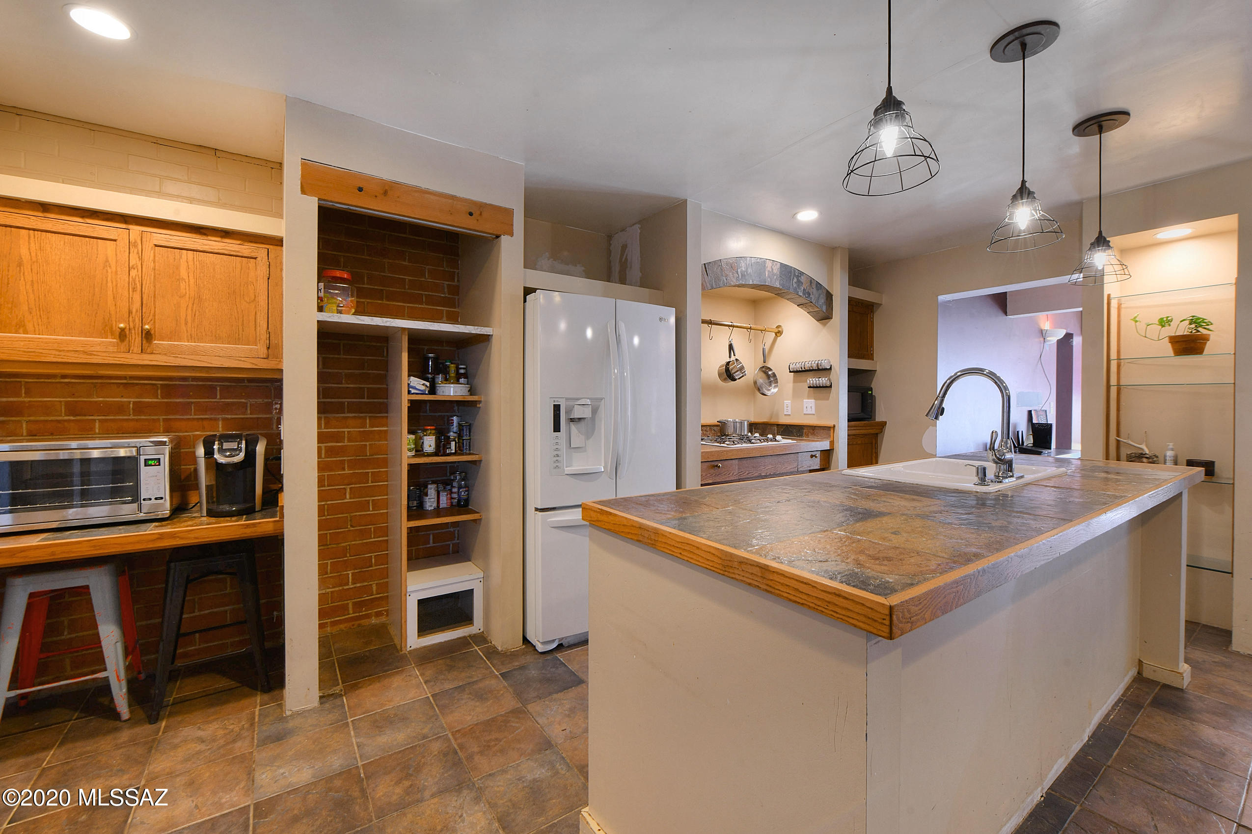 418 East Pastime Road Tucson, AZ 85705 - Photo 1 of 20 a kitchen with stainless steel appliances granite countertop a sink and a refrigerator