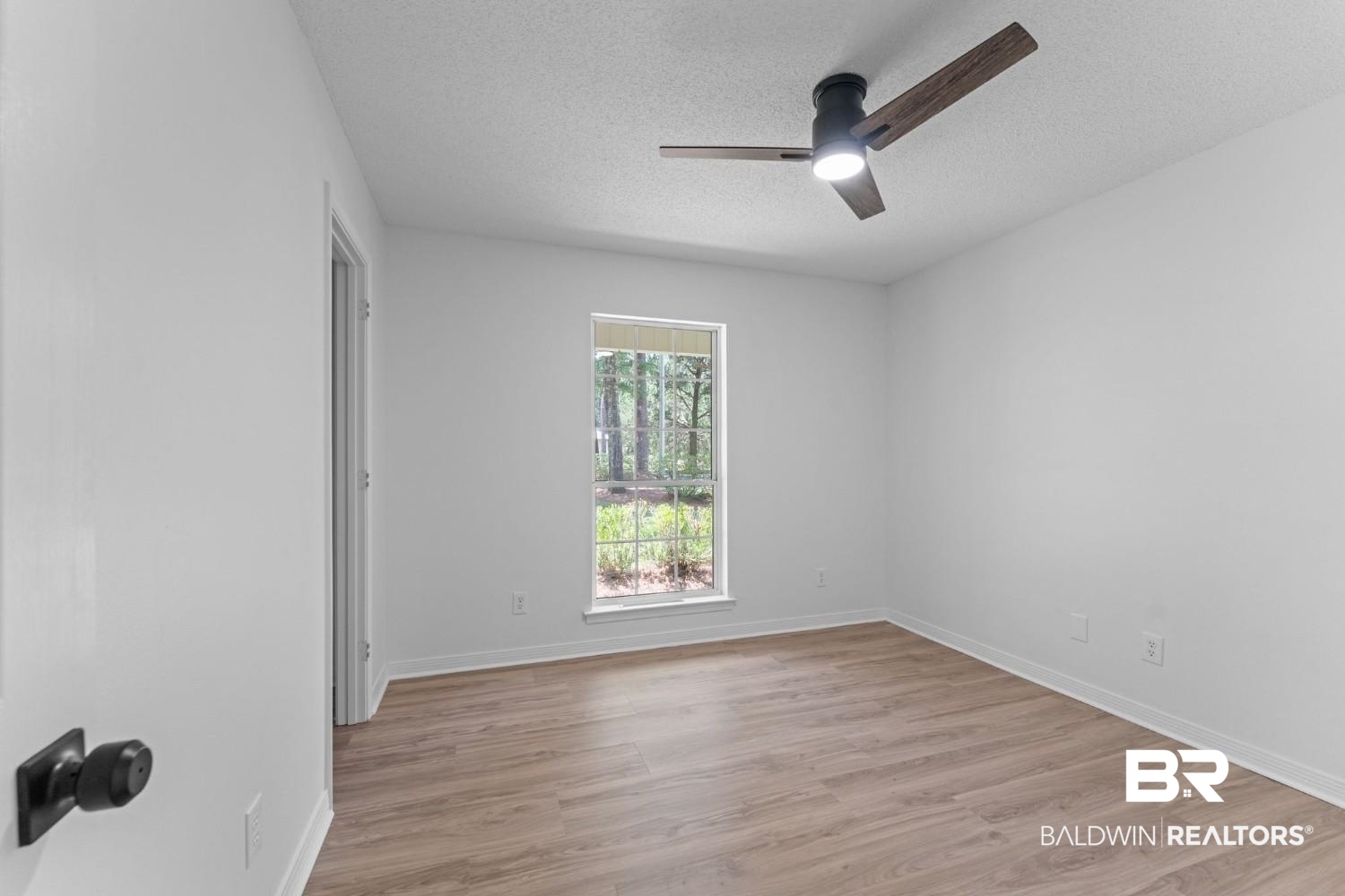 10251 Windmill Road Fairhope, AL 36532 - Photo 34 of 44 Empty room featuring a textured ceiling, a ceiling fan, and light wood-style flooring