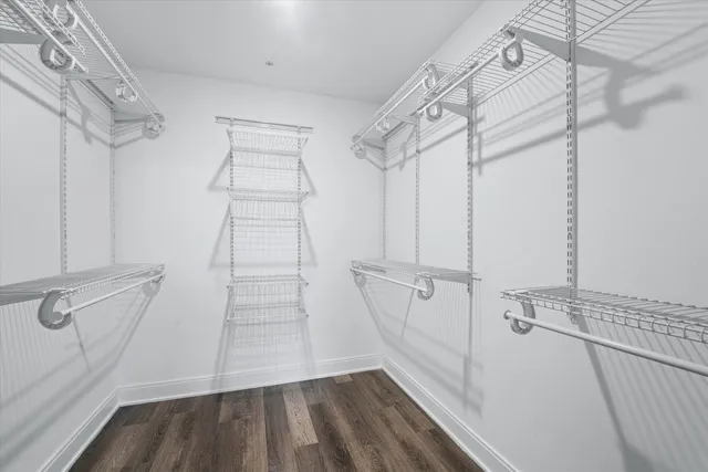 a view of walk in closet with empty racks