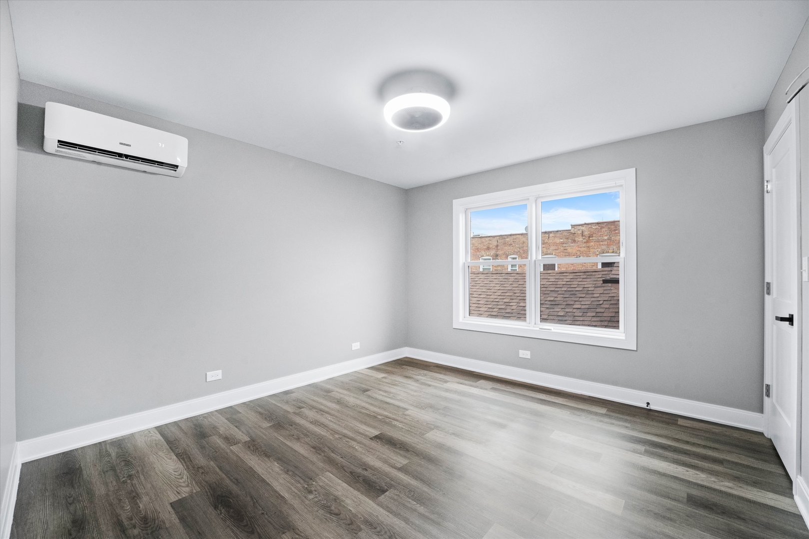 1016 South State Street, Unit 4 Lockport, IL 60441 - Photo 12 of 26 an empty room with wooden floor and windows