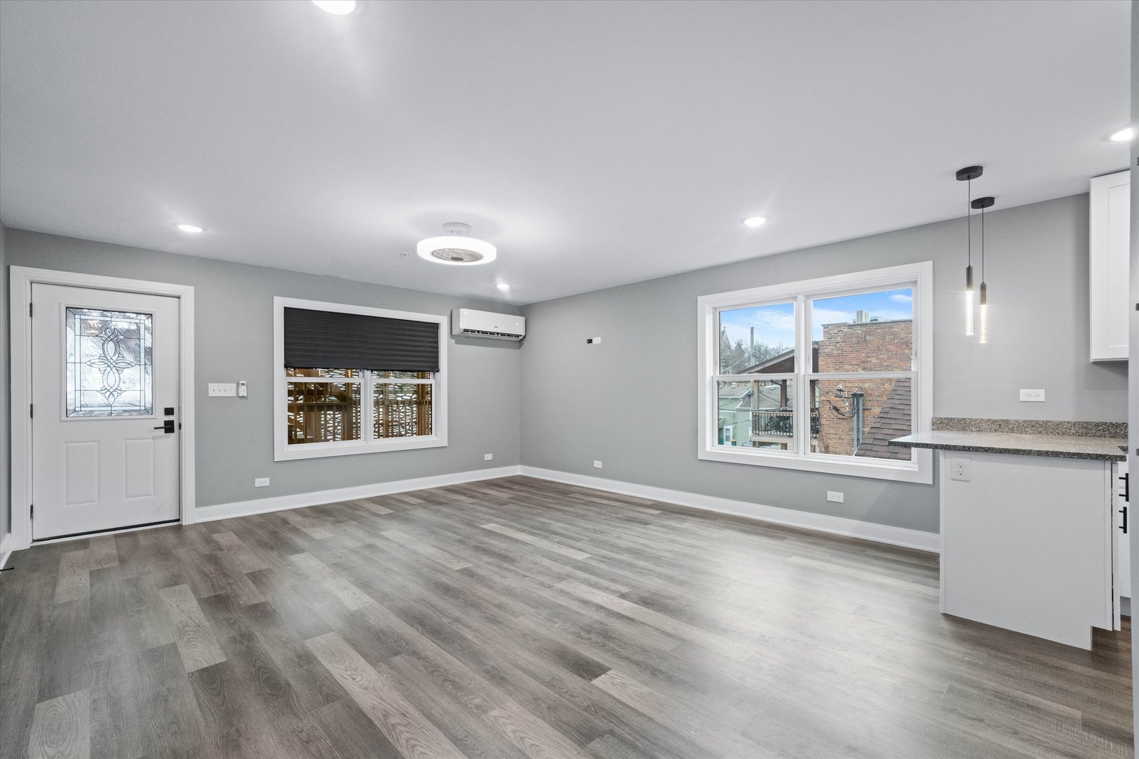 1016 South State Street, Unit 4 Lockport, IL 60441 - Photo 5 of 26 a view of an empty room with a window and wooden floor