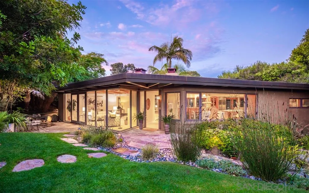 a view of a house with a backyard and a garden