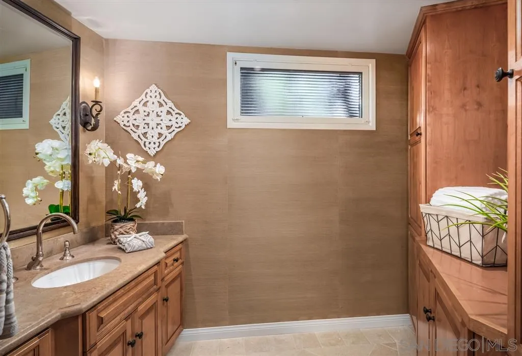 945 Crest Road Del Mar, CA 92014 - Photo 12 of 23 a bathroom with a sink a vanity and a mirror