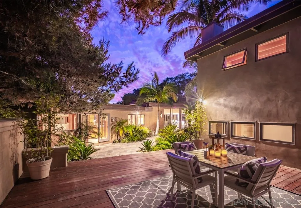 945 Crest Road Del Mar, CA 92014 - Photo 18 of 23 a view of a patio with table and chairs and potted plants