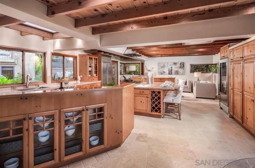 945 Crest Road Del Mar, CA 92014 - Photo 3 of 23 a open kitchen with stainless steel appliances granite countertop a sink and cabinets